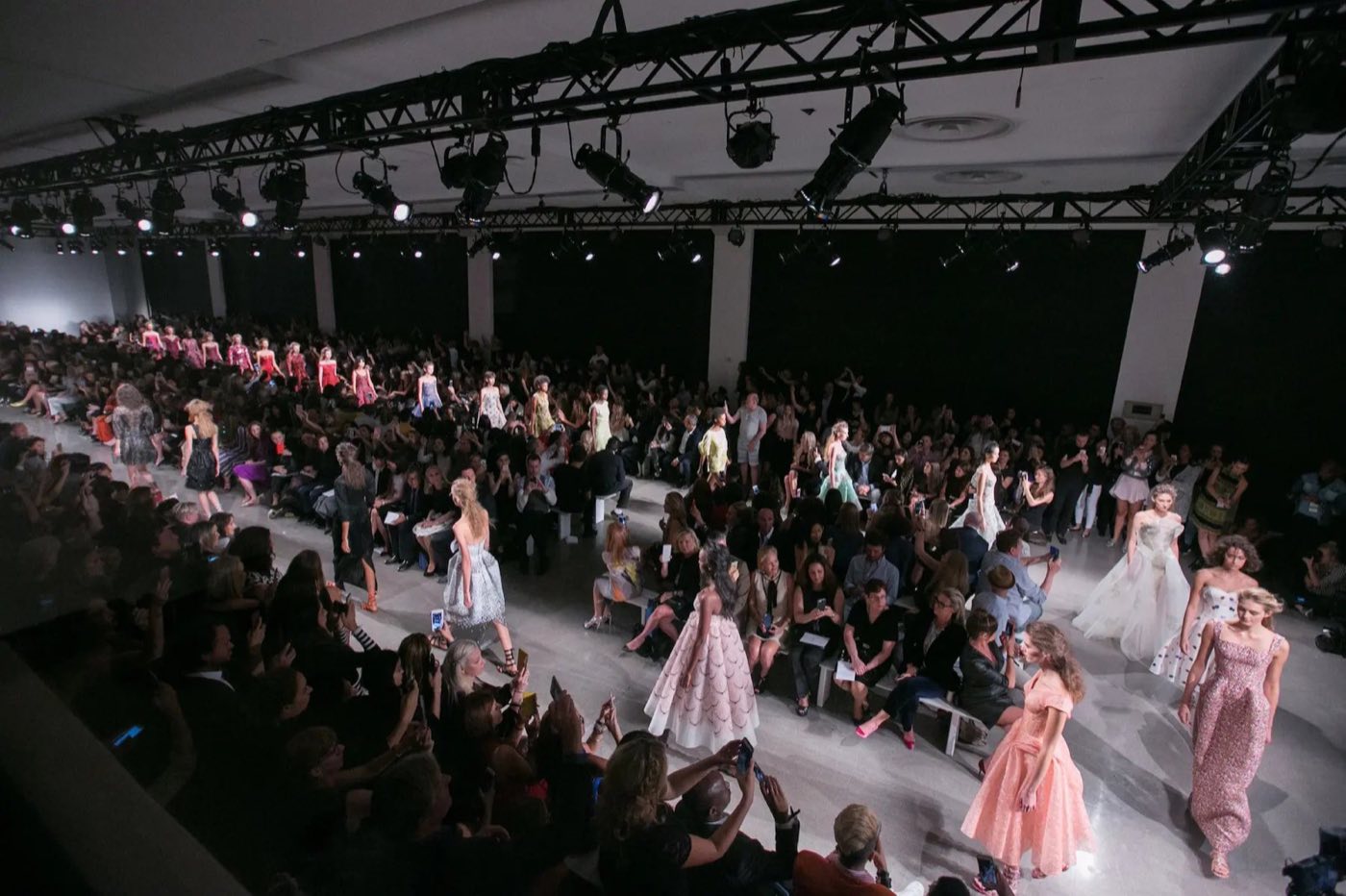 Runway show in the Studios with tiered seating along both sides