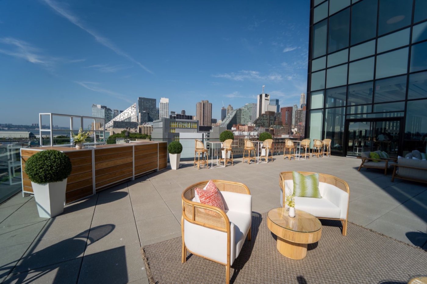 Rooftop terrace with lounge seating and views of the Midtown West skyline