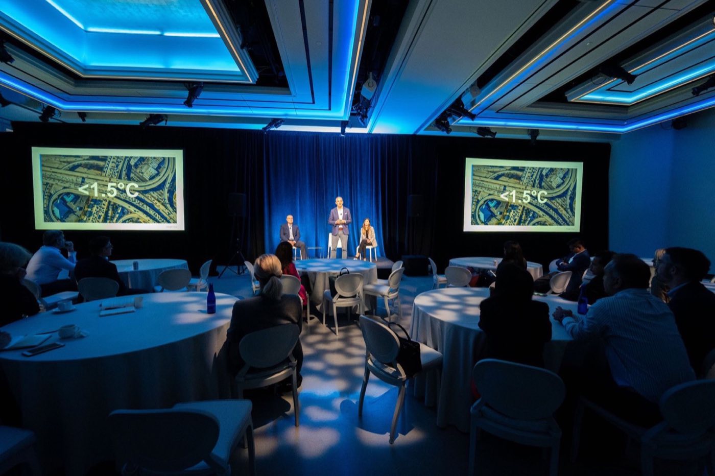 Suite set with round tables for a panel discussion with two side screens