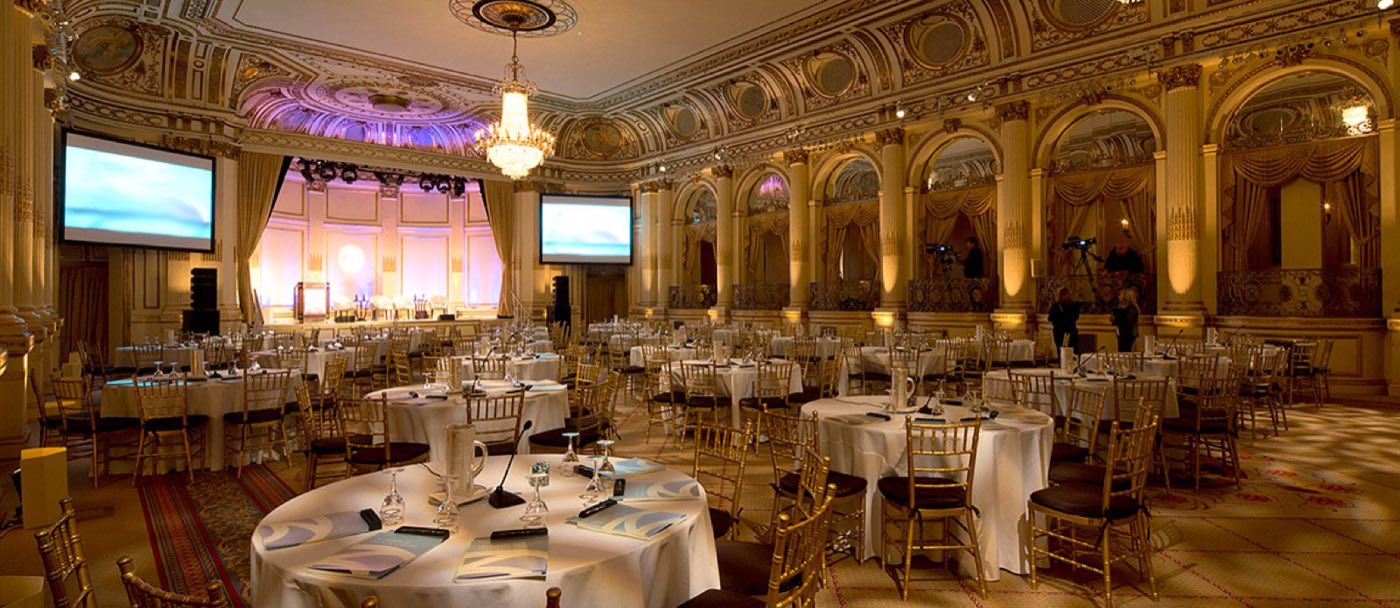 Grand Ballroom arranged for a meeting with round tables and two projection screens