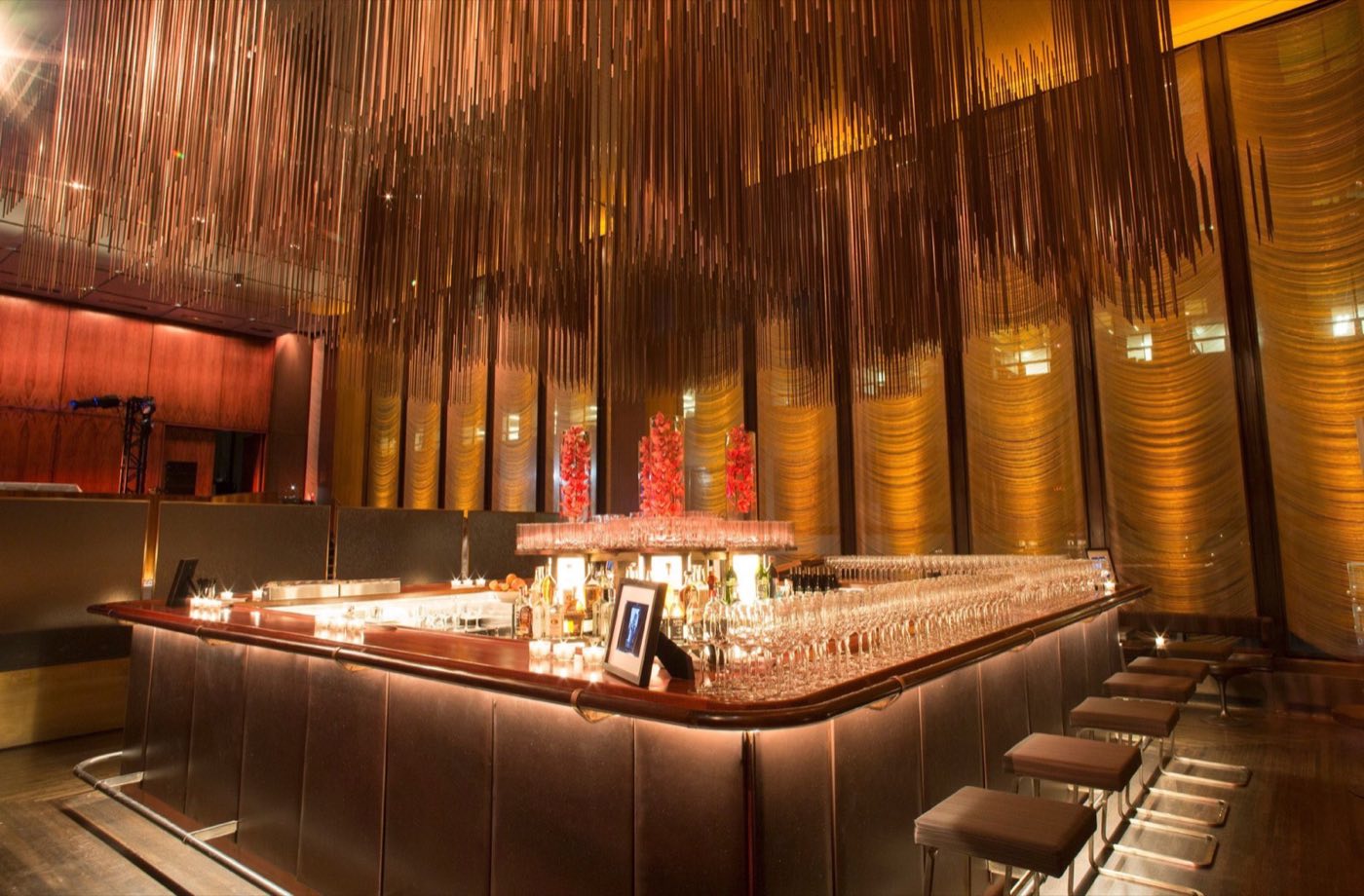 Grill bar with chain curtain ceiling and walnut paneled walls