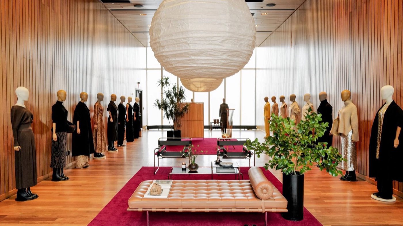 Wood-paneled room with a paper lantern set up for a fashion presentation