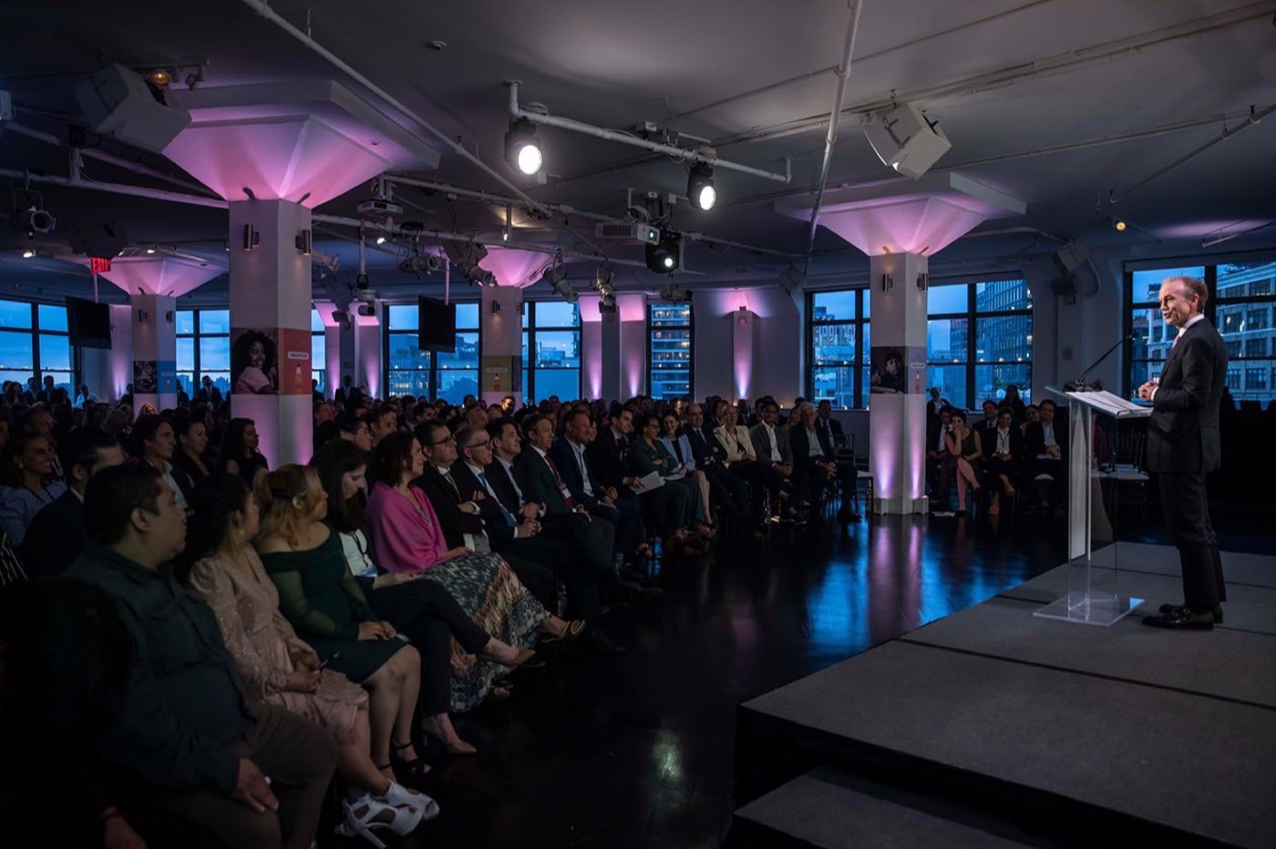 Presentation to a seated audience in Tribeca 360 with uplit columns