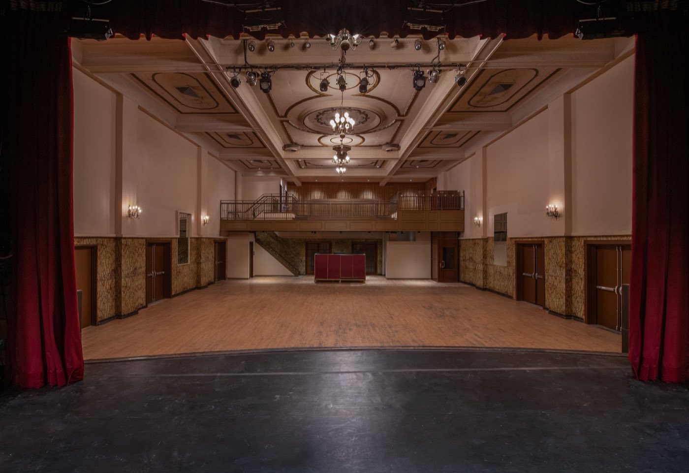 View from the stage across the empty hall toward the balcony