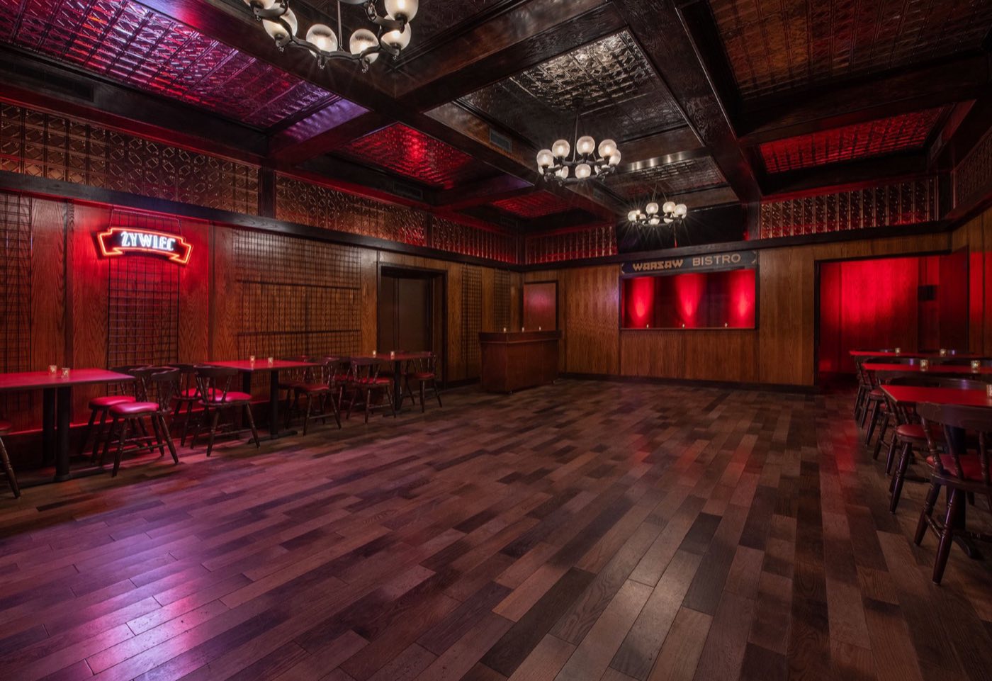 Pierogi Lounge with red lighting, wood floors and cafe tables
