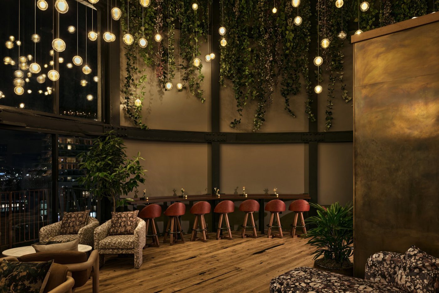 Water tower room at night lit by clusters of glass globe pendants