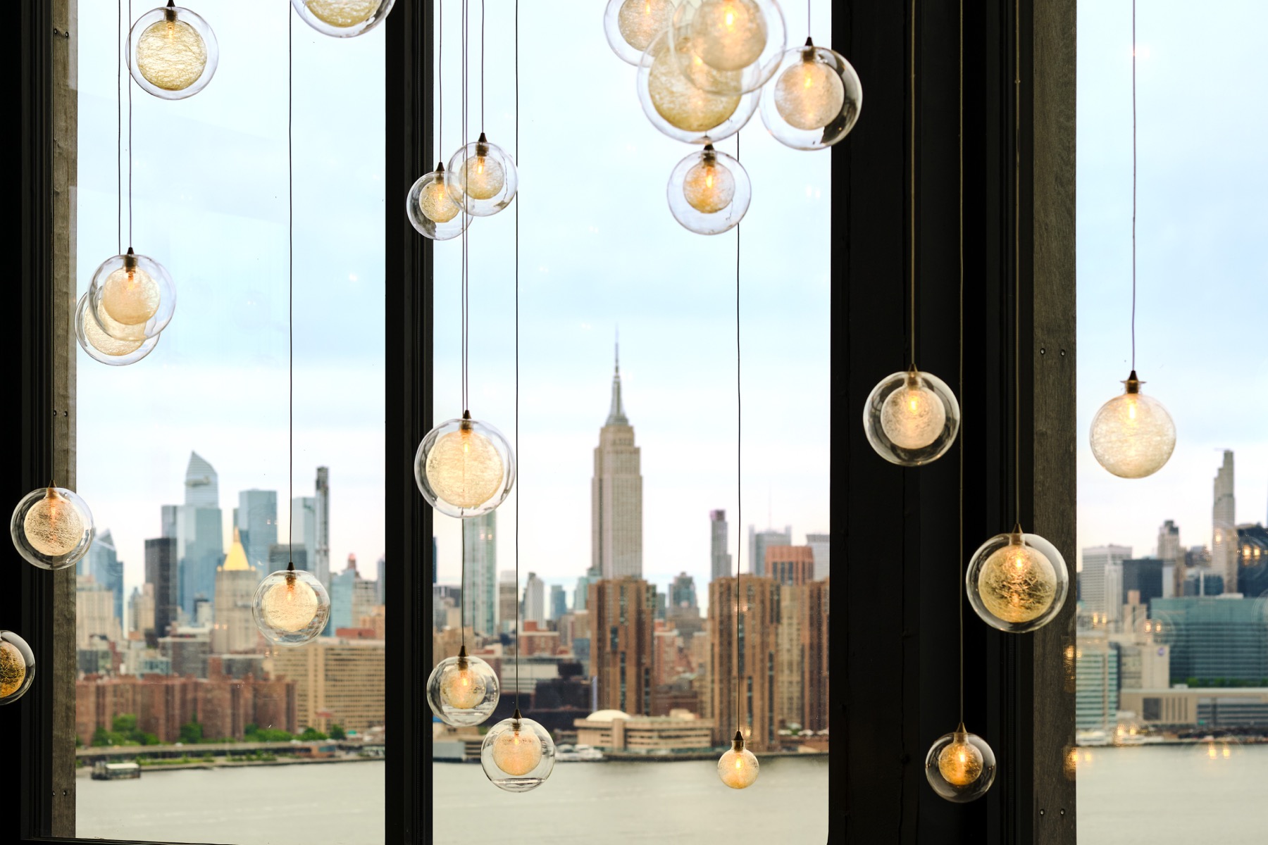 Midtown skyline framed by the tower windows and globe pendants