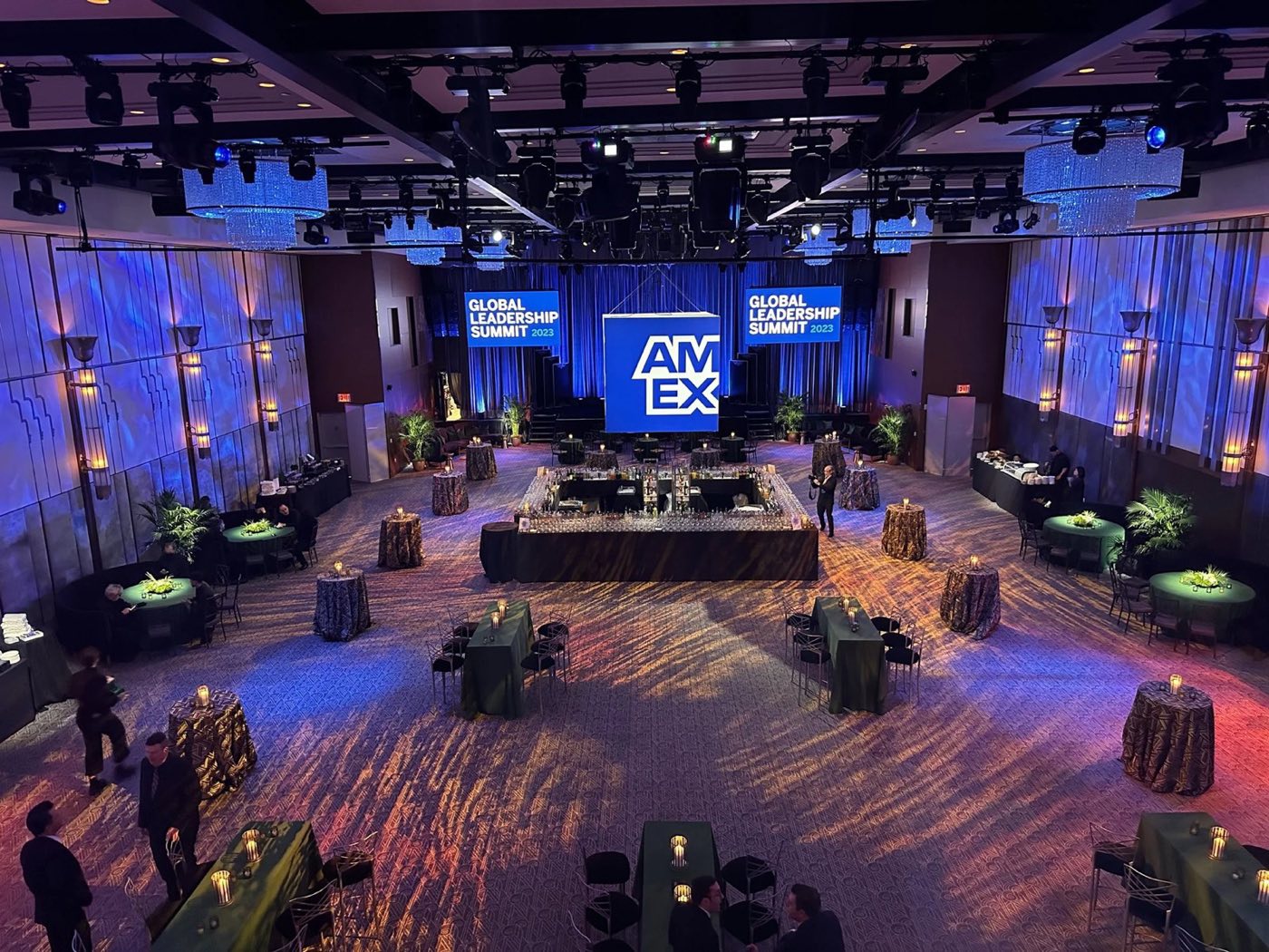 Branded stage and lounge furniture set on a patterned ballroom floor